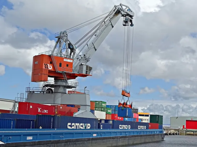 Container vessel being loaded at a cargo port