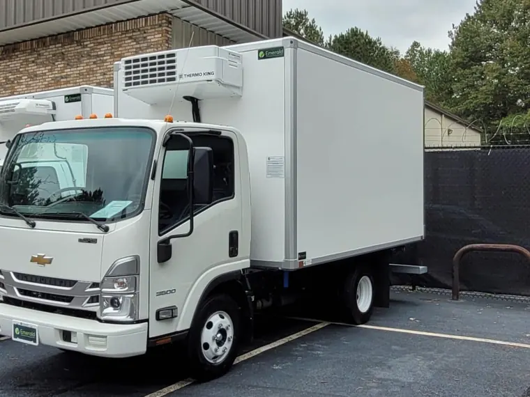 Refrigerated container being loaded onto a truck
